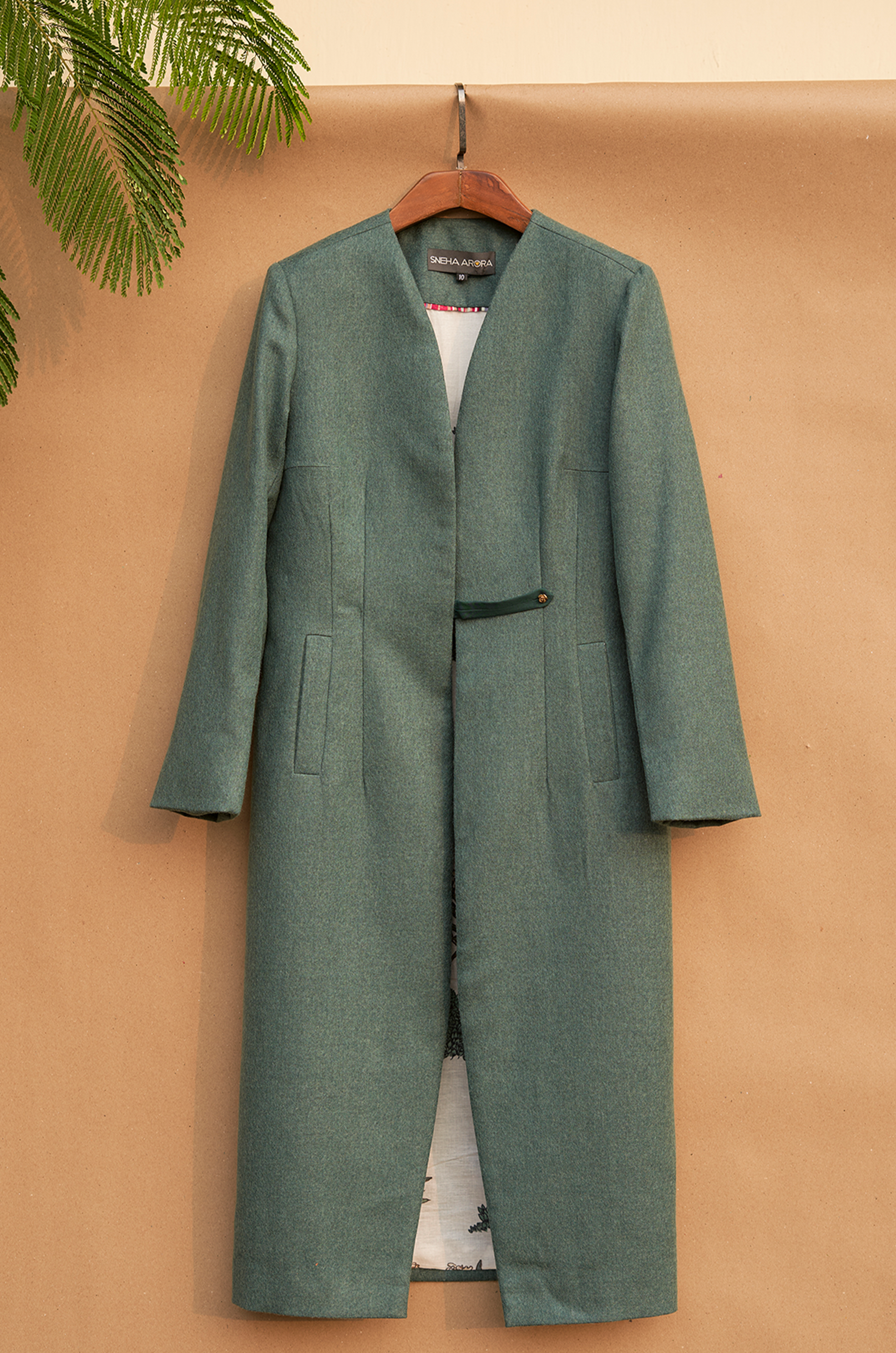 Green fitted jacket with a strap closure