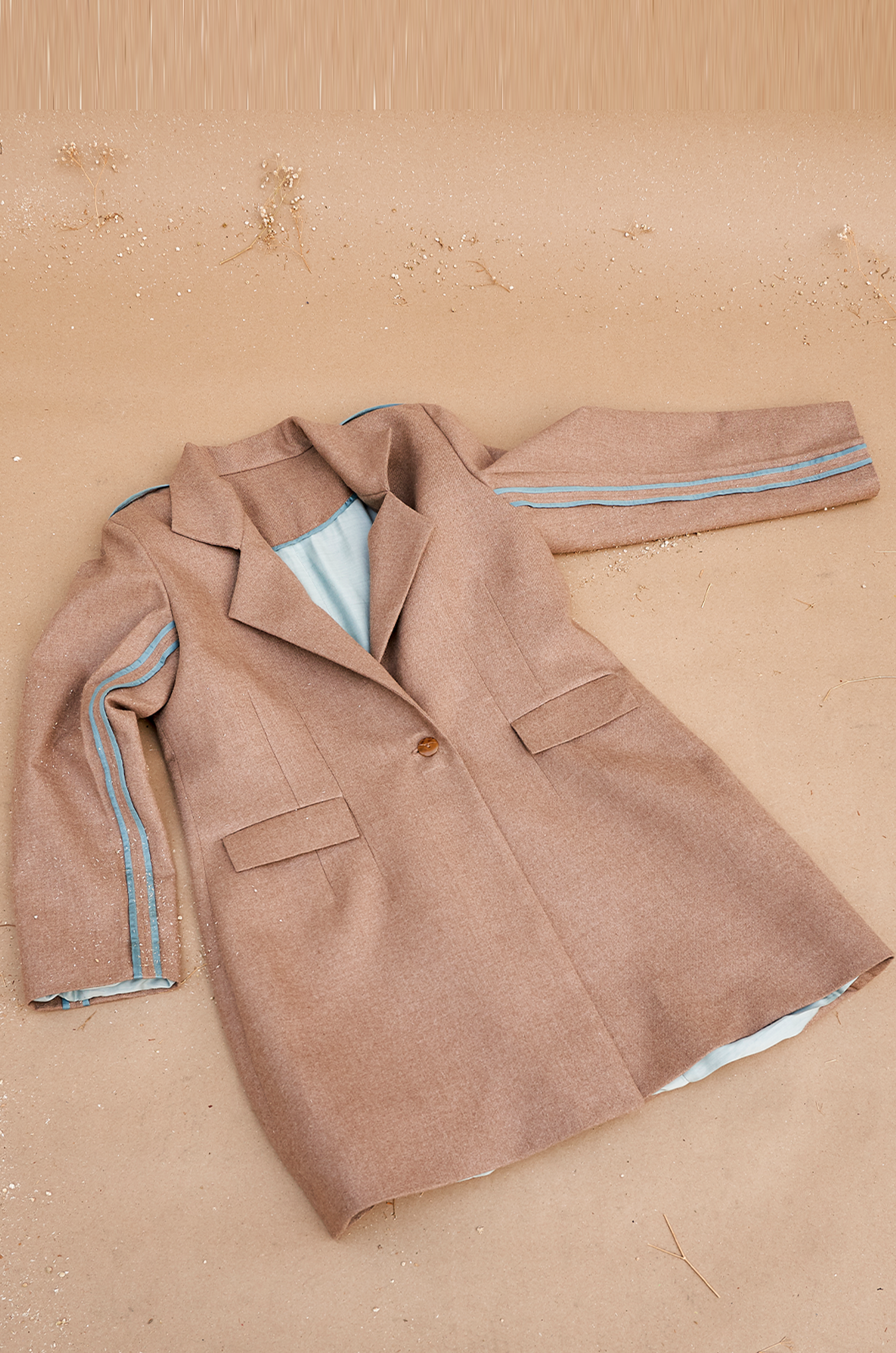 Beige knee length jacket with contrast piping
